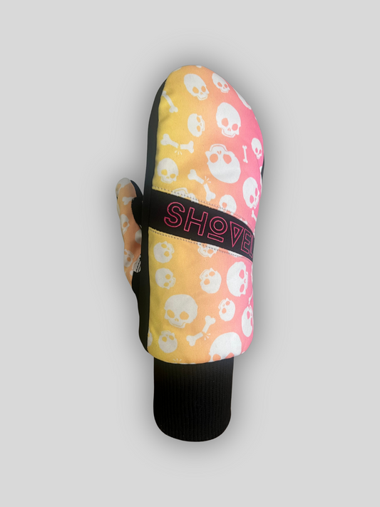 Shovel Snowsports Skull Mitts – black leather snowboard gloves with bold skull design on the front and silicone skull grip on the palm, shown on a grey background.